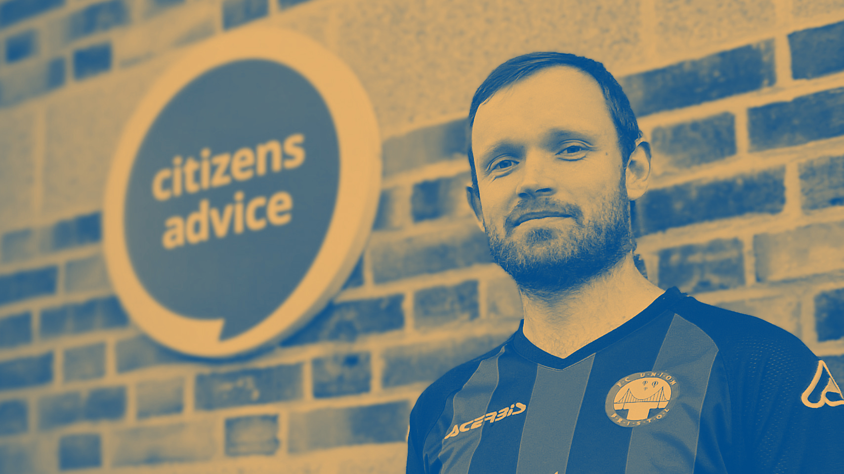 Julien Bristow-Goldschmidt, Help To Claim adviser based at Citizens Advice South Gloucestershire, standing next to the entrance of the charity's office in Yate. He is running the Bristol 10K to raise funds for the charity.