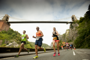 Runners underneath the Clifton Suspension Bridge in Bristol