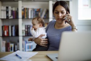 Serious adult woman with baby and phone