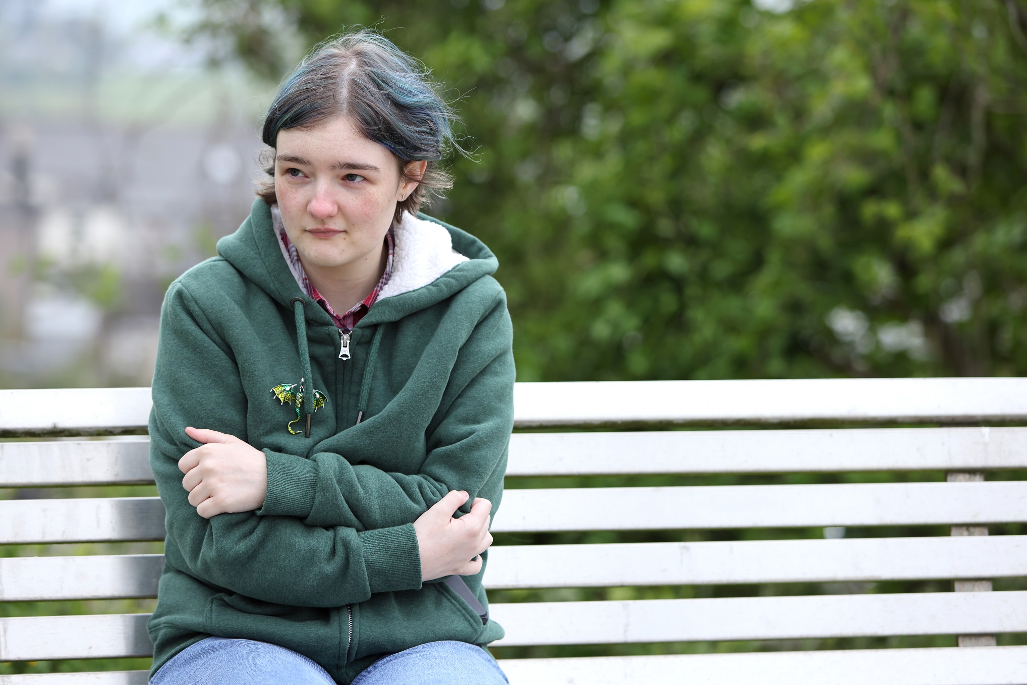 Serious woman sat on bench