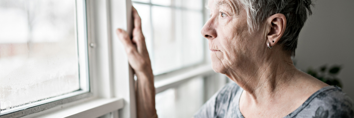 Serious woman looking out of window